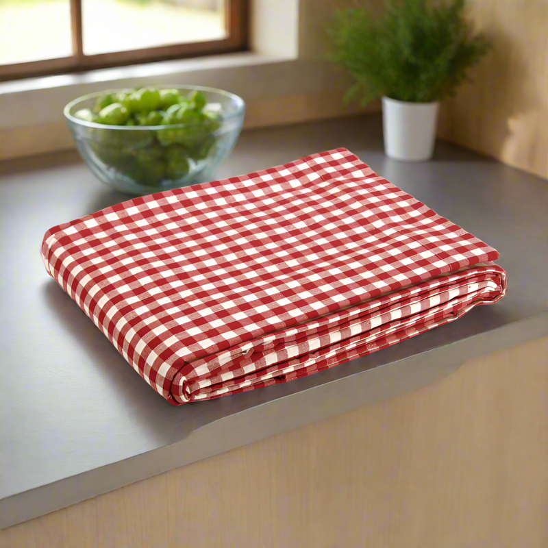 Folded red gingham table on a kitchen bench 