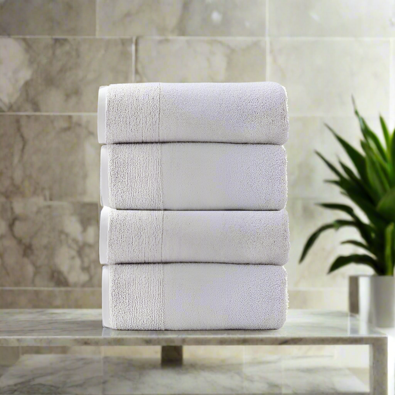 Light grey bath towels in a stack 