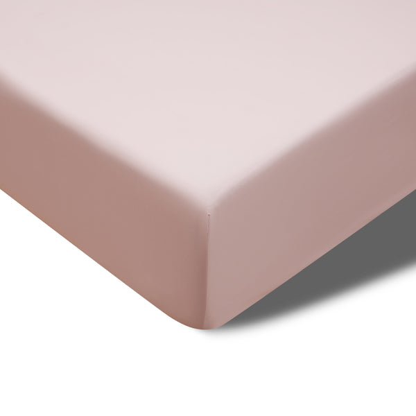 A close up of a blush fitted sheet of Accesorize Bamboo Cotton, offering temperature control and a generous fit for high-top mattresses.