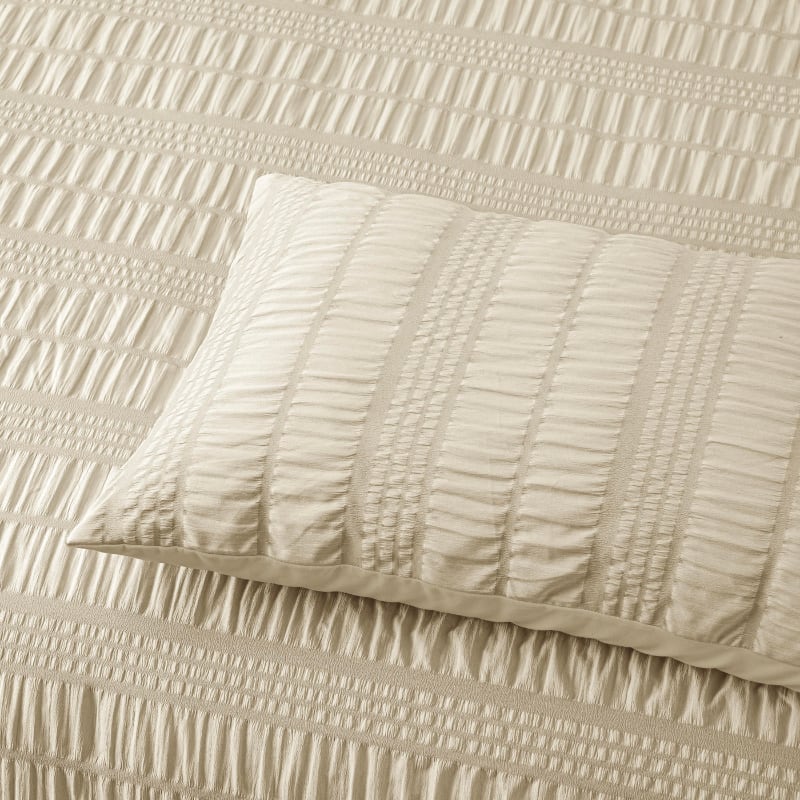 Close up details of a natural quilt cover set, featuring a rich seersucker texture for added depth and warmth.