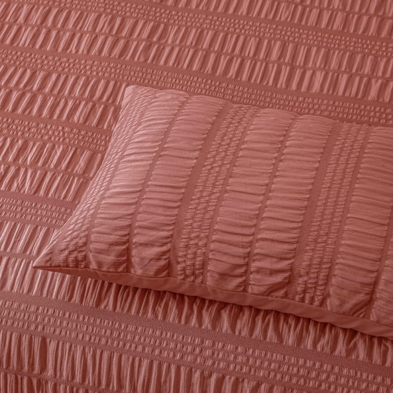 Close up details of a tobacco quilt cover set, featuring a rich seersucker texture for added depth and warmth.