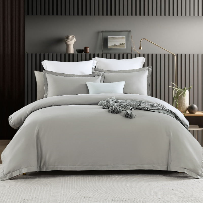 Elegant bed with silver quilt cover set and fitted sheet, featuring Amor 400 Thread Count for ultimate comfort.