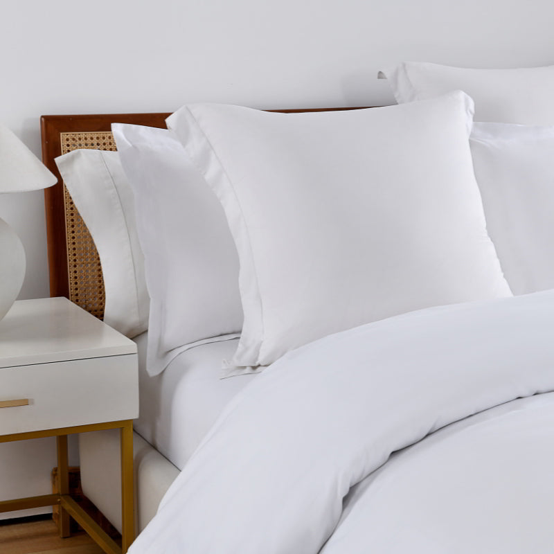 Close up details of the luxurious white bedding featuring a quilt cover set and fitted sheet, crafted from 100% premium Egyptian cotton for ultimate comfort.