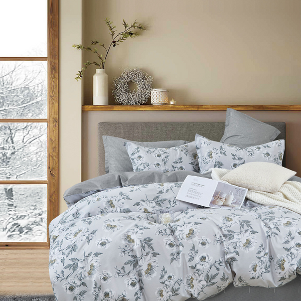 A serene cover set featuring a floral-patterned bed, enhancing the tranquil atmosphere.