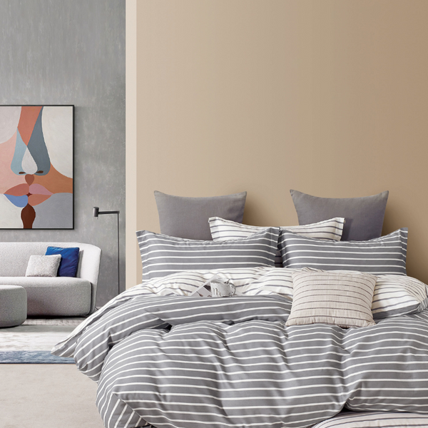 A modern bedroom displaying a grey and white striped quilt cover, emphasising the comfort and reversible style of the Ardor Anderson Quilt Cover Set.