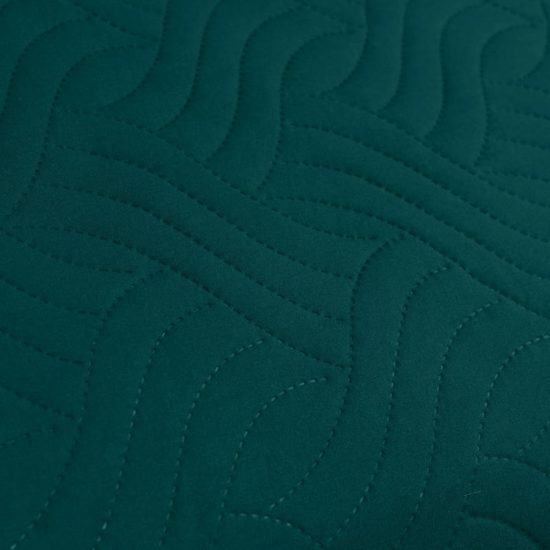 Detailed view of a deep teal quilt cover, adding a touch of sophistication and comfort to a serene bedroom retreat.