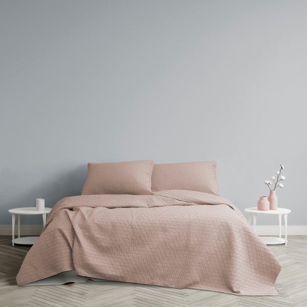 Fresh colour of powder pink paired with the floral quilting coverlet set in a cosy bedroom