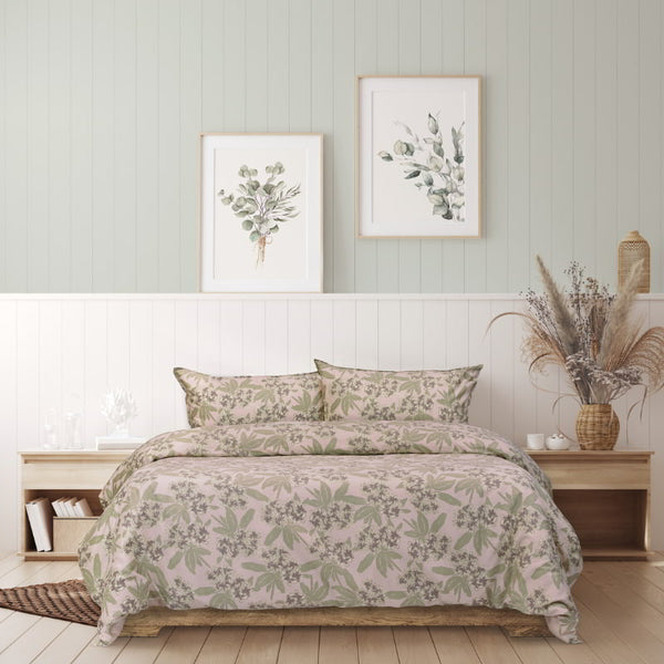 A peaceful bedroom scene with a green wall, featuring the exquisite Jasmine Quilt Cover Set for serene comfort.