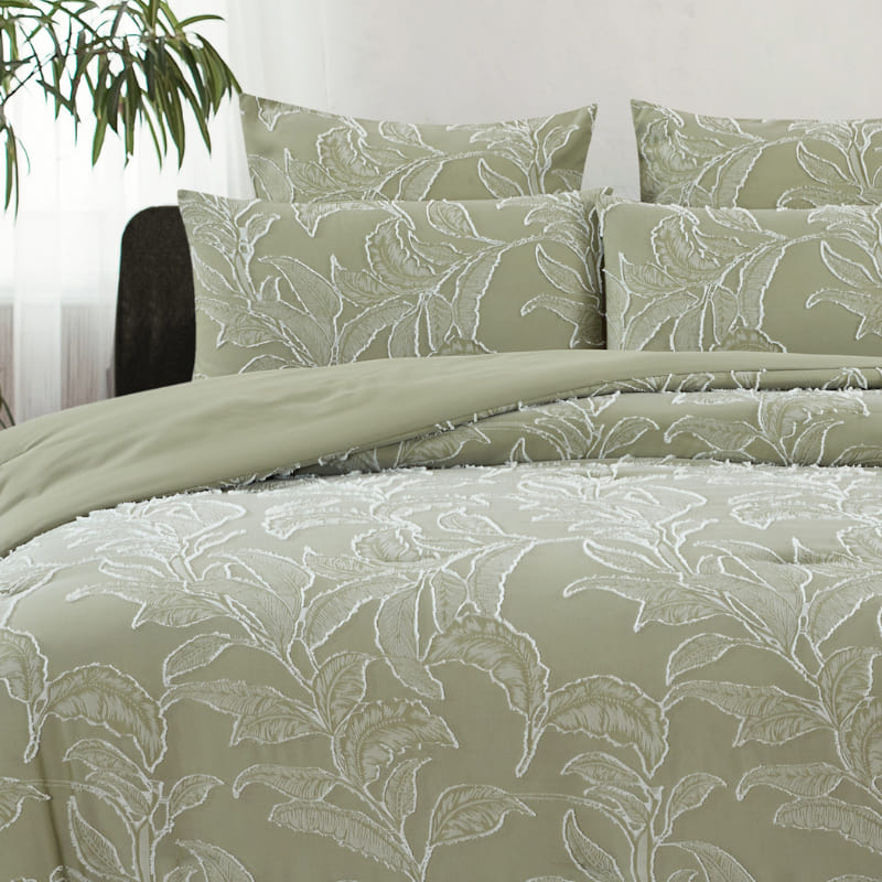 alt="A pale olive quilt cover set features a beautifully textural tropical design front with a plain dyed reverse."