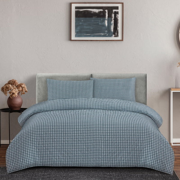 Stylish bedroom with a teal checkered quilt cover set, blending classic charm and modern comfort for a relaxing atmosphere.