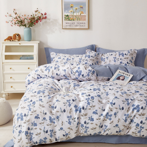 A blue and white floral cover set. Exuding elegance and tranquility in a serene bedroom setting.