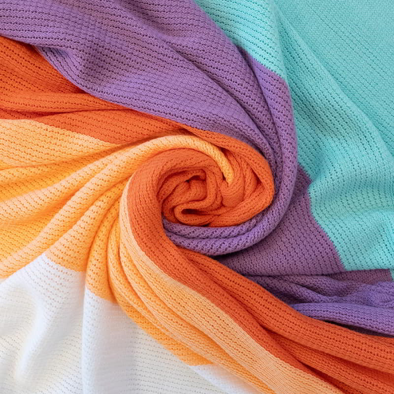 A close-up look of the colourful Azalea Throw blanket, ideal for enhancing the decor of your home.