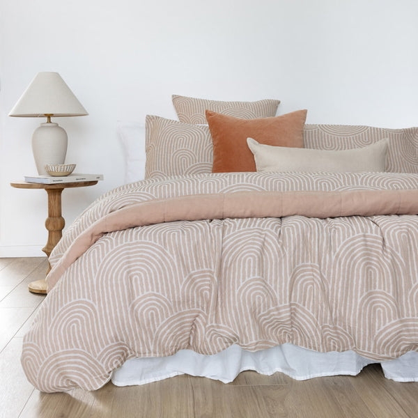 A stylish bed adorned with a brown quilt cover set, enhancing the room's warm and inviting atmosphere.