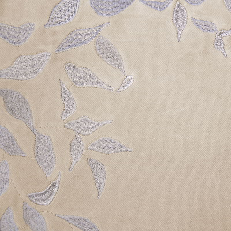 Detailed view of a natural tone cushion made from luxurious cotton velvet with delicate leaf embroidery, brings nature-inspired elegance to your home.