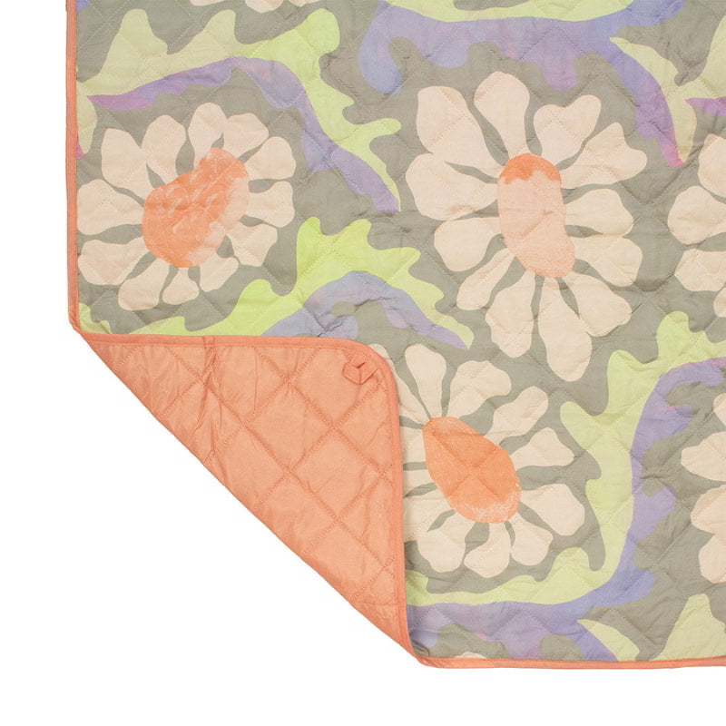 Close-up view of the Sadie Orange Picnic Rug featuring a vibrant floral pattern, perfect for outdoor activities and enhancing picnic experiences.