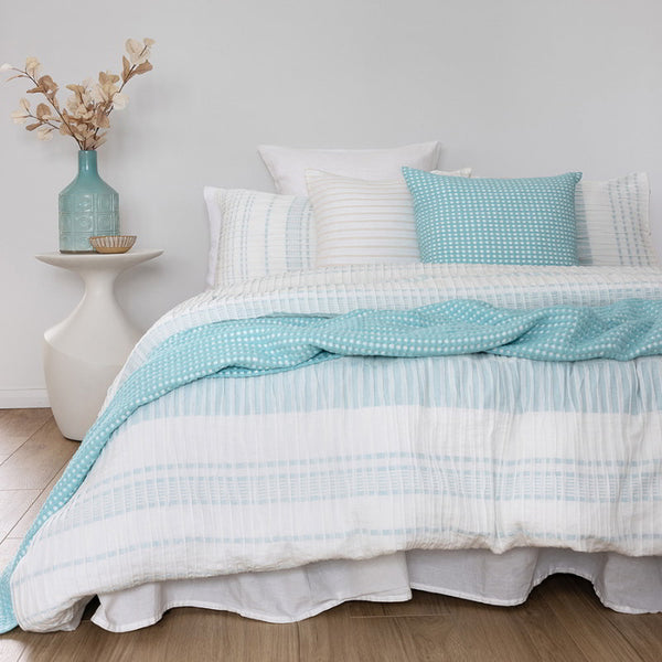 A cosy bed featuring white quilt cover set, perfect for creating a tranquil and stylish bedroom retreat.