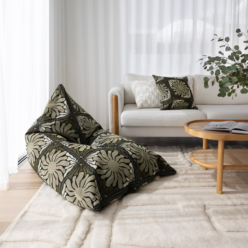 A cosy living room featuring a green floral-patterned bean bag enhances  living space's warmth and beauty.