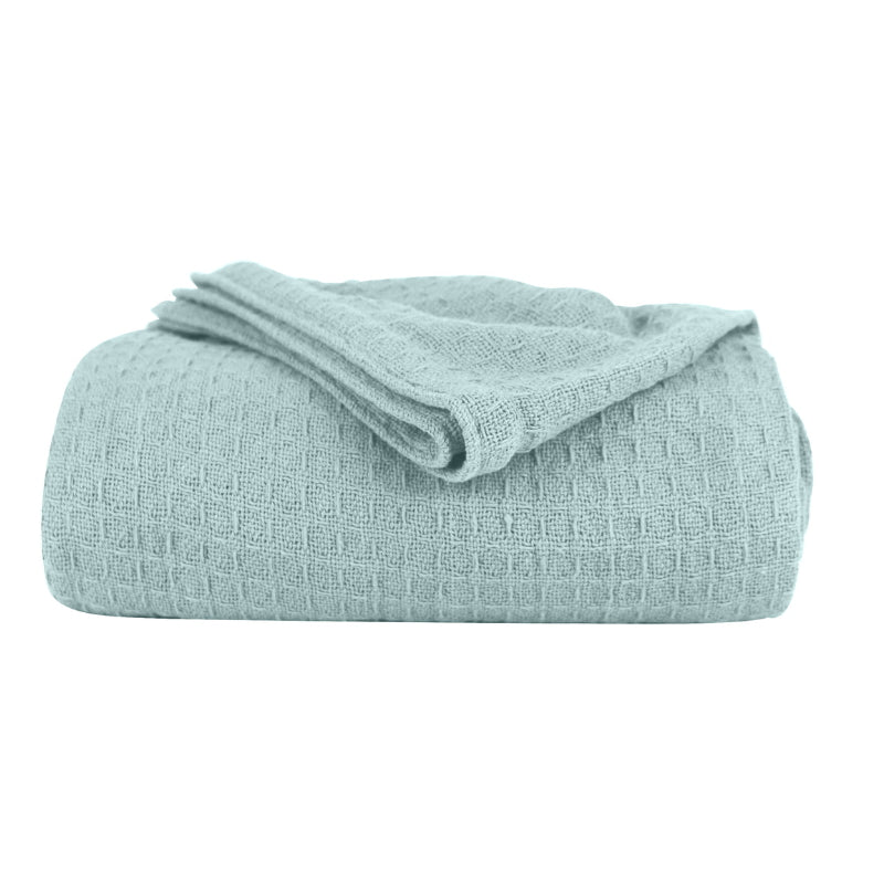 A blue cotton blanket featuring its luxuriously soft and resilient Cotton with added polyester.