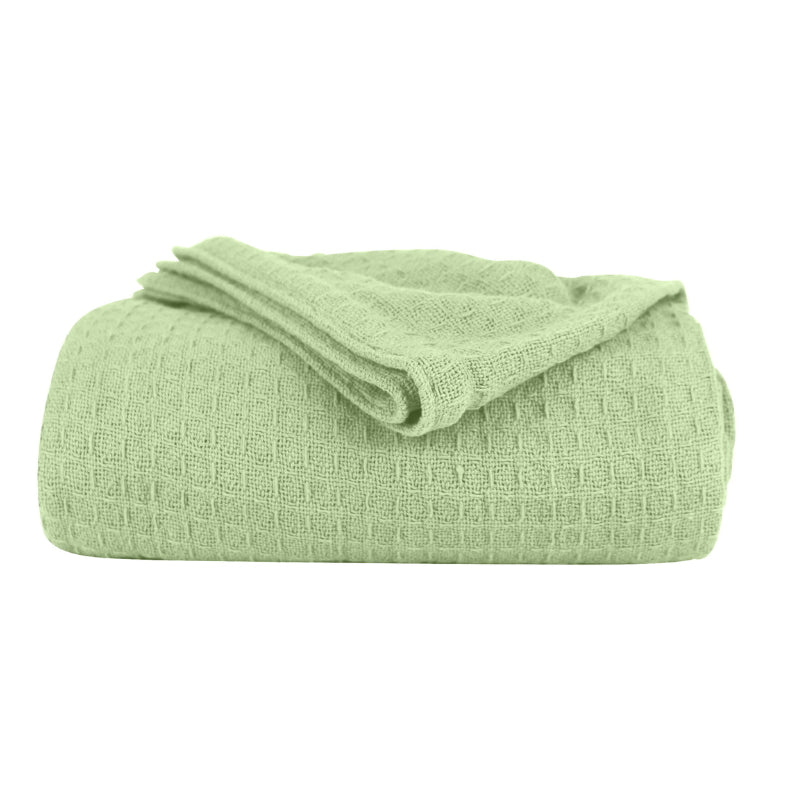 A green Cotton Blanket featuring its luxuriously soft and resilient Cotton with added polyester.