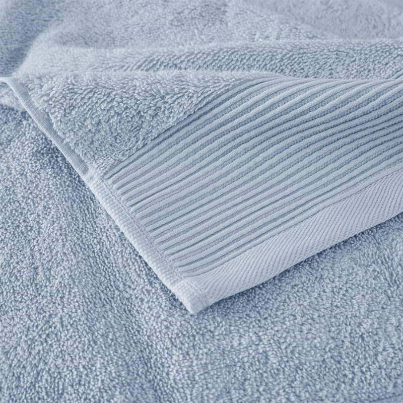 Zoom in details of a luxurious blue towels made from eco-friendly Tencel and cotton, promoting sustainability and advanced hygiene.