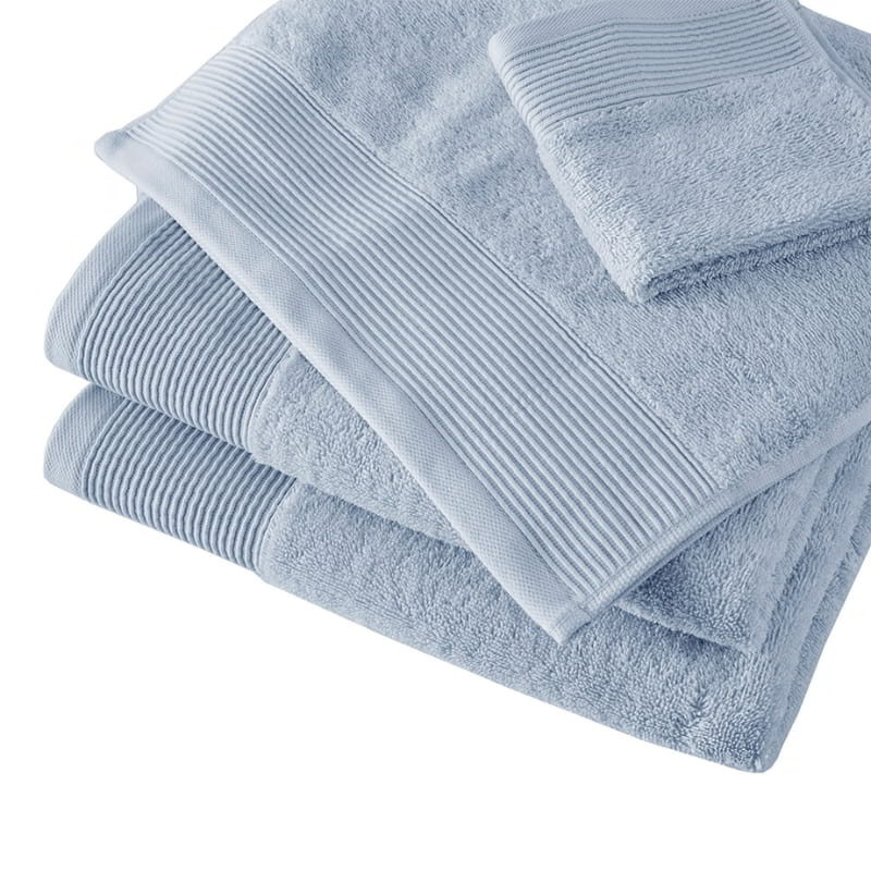 A collection of soft blue towels, made from eco-conscious Tencel and cotton, designed for luxury and effective hygiene.