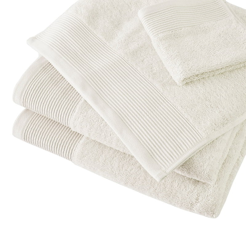 A collection of soft ivory towels, made from eco-conscious Tencel and cotton, designed for luxury and effective hygiene.