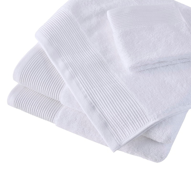 A collection of soft white towels, made from eco-conscious Tencel and cotton, designed for luxury and effective hygiene.