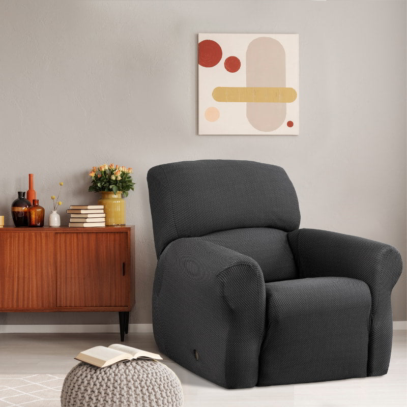 A grey recliner chair covered with a textured slipcover, enhancing comfort and style in a contemporary living space.