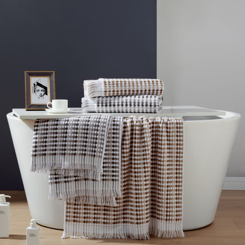 A stylish bathroom display with a bathtub, and plush bath linens, highlighting comfort and sophisticated design.