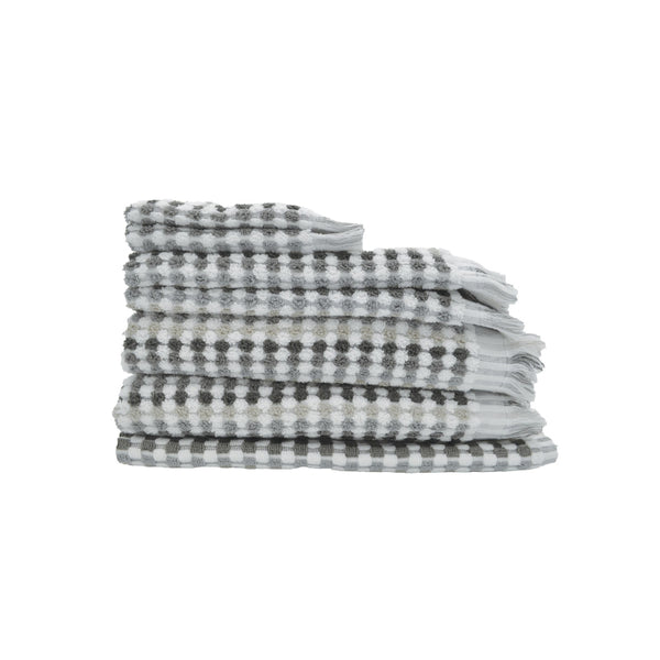 A neatly arranged stack of towels with a grey and white checker design, offering a blend of style and comfort for your bathroom.