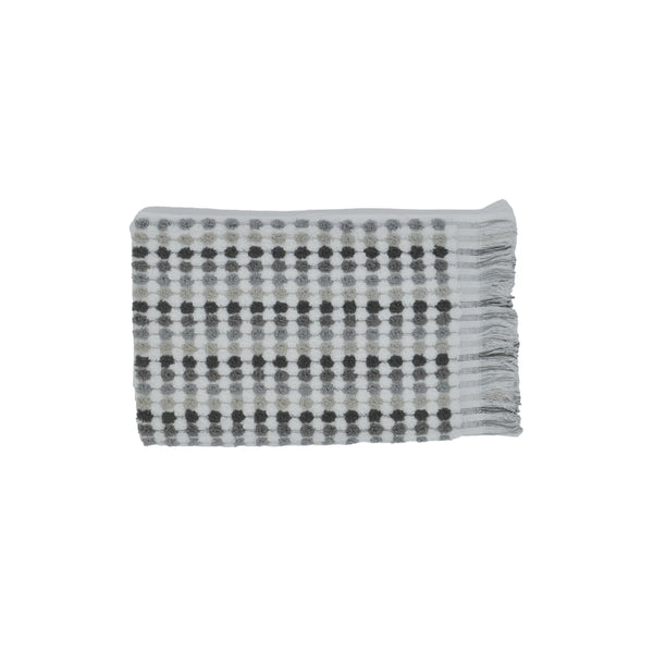 Luxurious grey cotton hand towel with modern fringes, offering softness and absorbency for a stylish bathroom experience.