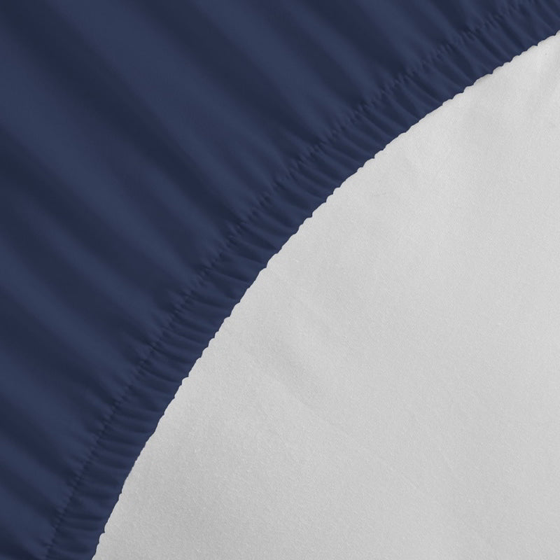 Detailed view of a Jenny Mclean Porto Navy fitted sheet, highlighting the luxurious feel of the cotton fabric.