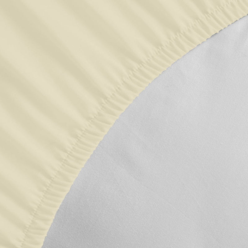 Detailed view of a Jenny Mclean Porto Vanilla fitted sheet, highlighting the luxurious feel of the cotton fabric.