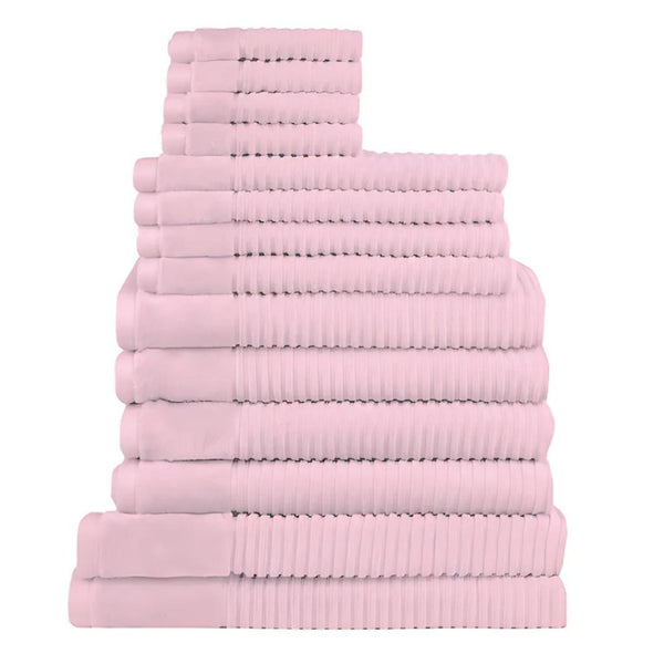 Fourteen plush baby pink towels arranged in a stack, highlighting their softness and absorbency, ideal for enhancing daily rituals.