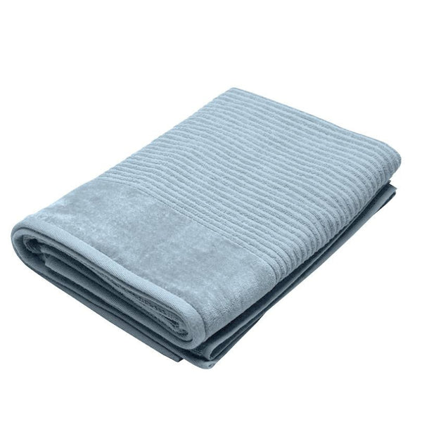  A folded baby blue towel on a white background, showcasing its luxurious texture and premium quality.