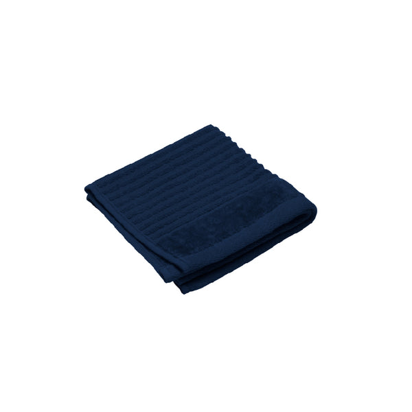  A neatly folded navy face towel against a white backdrop, highlighting its premium cotton fabric and plush, absorbent texture.