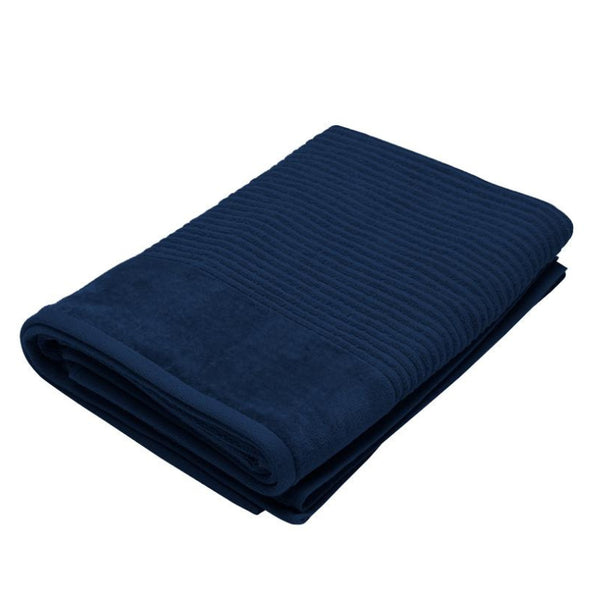  A soft navy towel laid flat on a clean white background, showcasing its luxurious texture and quality.