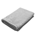 Neatly folded grey towel against a white backdrop, showcasing the luxurious feel of the Jenny Mclean Royal Excellency Towel Pack.