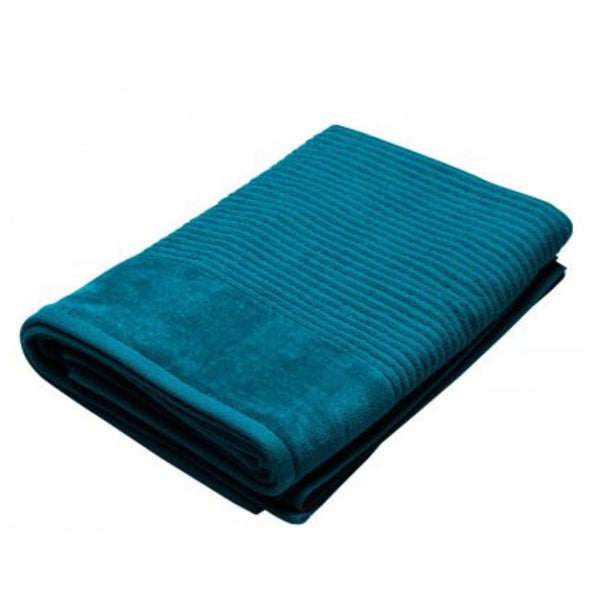 A folded teal towel on a white background, showcasing its soft, premium cotton texture and luxurious appearance.