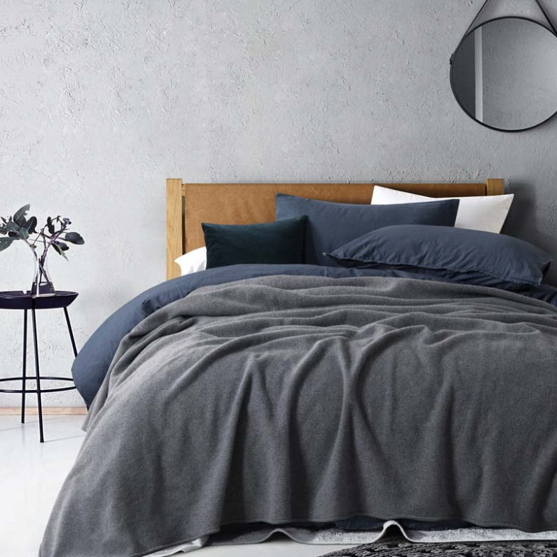 A bed with grey blanket of Laconia that is made from premium Australian pure new wool.