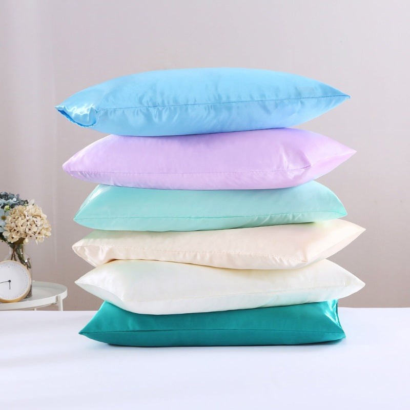 Six colourful pillows stacked together, featuring the luxurious Silky-smooth Texture Standard Pillowcase from Linenova for a comfortable sleep.