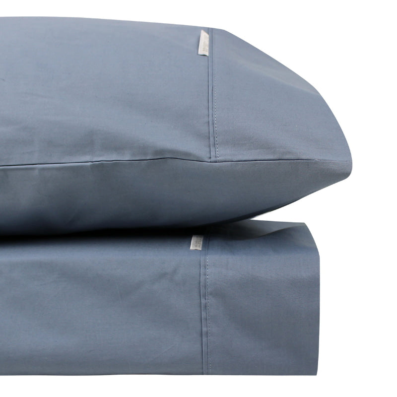 Close-up look of a steel blue sheet set made from 100% cotton showcasing fresh appearance, ultimate softness and cottony comfort.