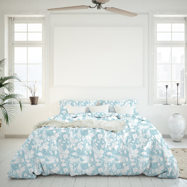 White and blue comforter in a bedroom, adding a touch of organic beauty.