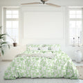 White and green comforter in a bedroom, adding a touch of organic beauty