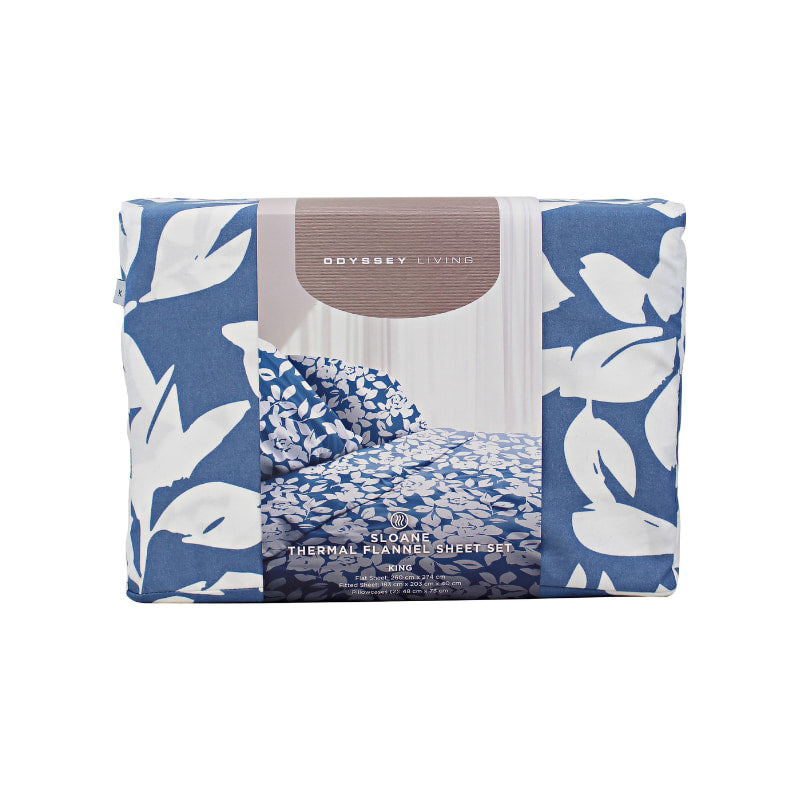 Front packaging details of a blue bed sheets and pillows, adorned with a monochromatic white floral and foliage pattern, craft a serene and unique design.