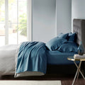 Stylish indigo bed adorned with premium Egyptian cotton sheet set of Park Avenue for exceptional comfort and elegance.