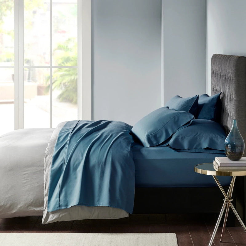 Stylish indigo bed adorned with premium Egyptian cotton sheet set of Park Avenue for exceptional comfort and elegance.