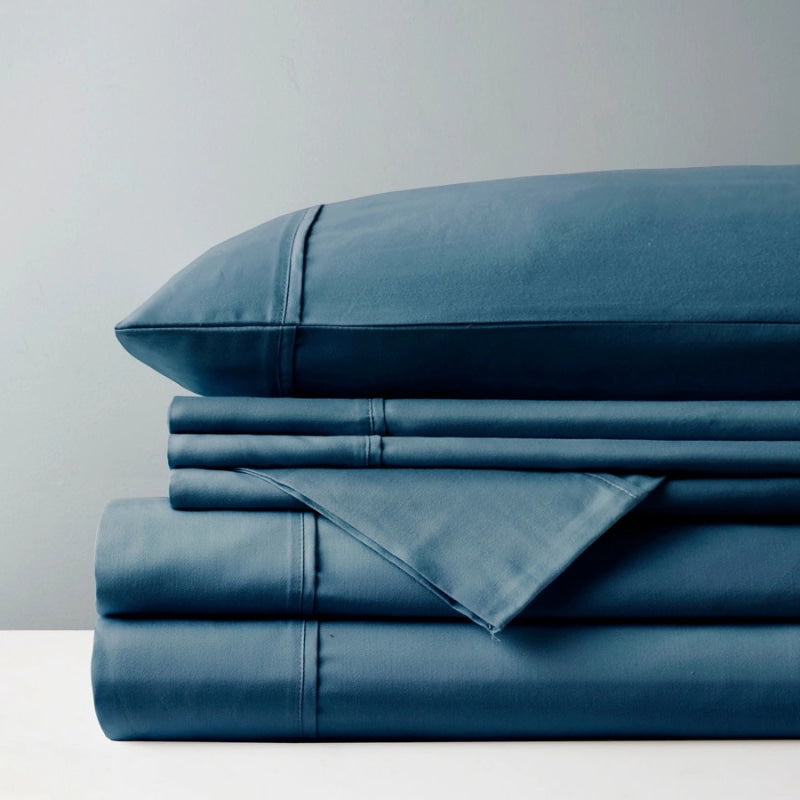 A pile of indigo sheet set, representing the luxurious comfort and stylish design of Park Avenue.