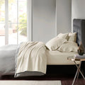 Stylish oatmeal bed adorned with premium Egyptian cotton sheet set of Park Avenue for exceptional comfort and elegance.