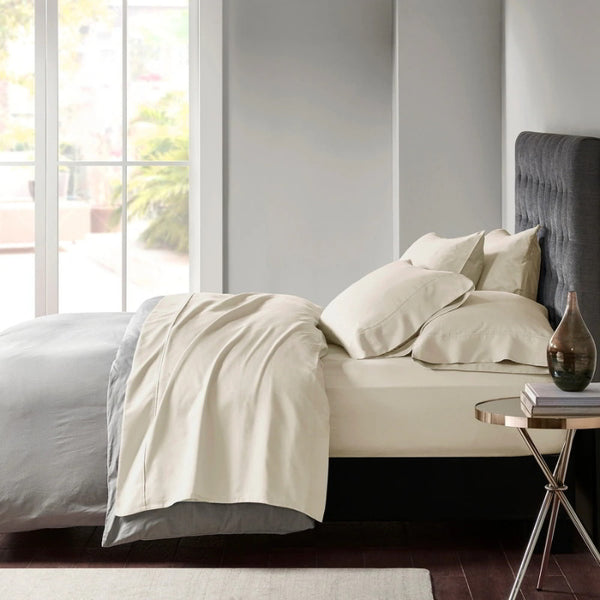 Stylish oatmeal bed adorned with premium Egyptian cotton sheet set of Park Avenue for exceptional comfort and elegance.